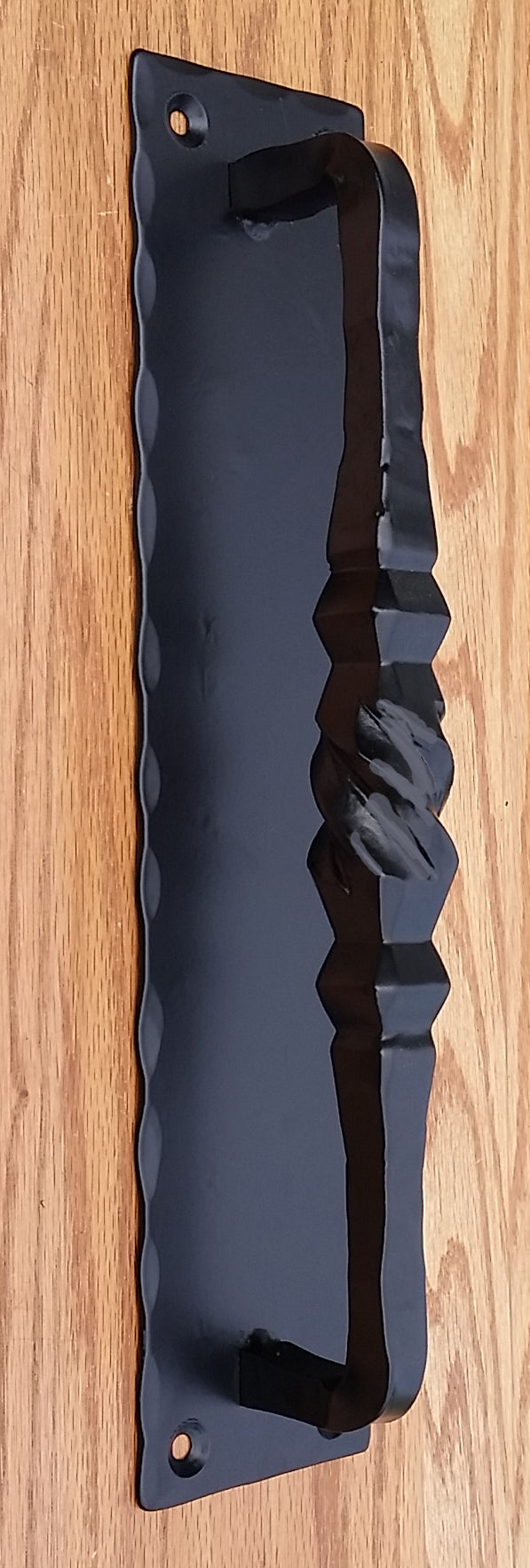 A Tuscan-style door handle measuring 4 inches